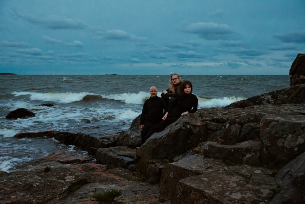 Kuvassa yhtye Trio Pauha kallioilla meren rannassa.